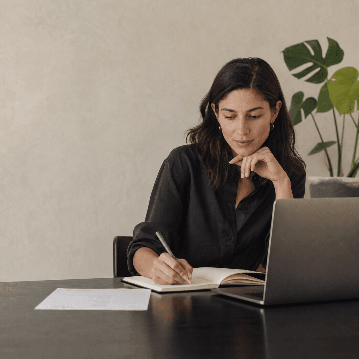 A professional thoughtfully planning her next career move at a calm home workspace